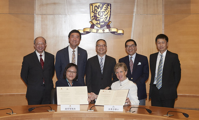Professor Poon Wai-yin  (left, front row), Pro-Vice-Chancellor, The Chinese University of Hong Kong (CUHK), and Dr Trisha Leahy BBS (right, front row), Chief Executive, Hong Kong Sports Institute (HKSI), sign the MOU, with the signatures witnessed by The Hon Lau Kong-wah JP (middle, back row), Secretary for Home Affairs,  Mr Yeung Tak-keung JP (1st  from right, back row), Commissioner for Sports, Professor Joseph Sung SBS JP (2nd from left, back row), Vice-Chancellor and President, CUHK, Professor Michael Hui (1st from left, back row), Pro-Vice-Chancellor, CUHK, and Mr Carlson Tong SBS JP (2nd from right, back row), Chairman, HKSI and University Grants Committee.