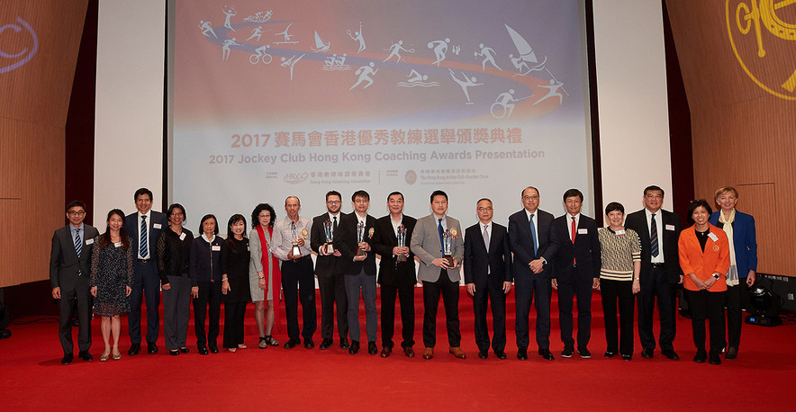 <p>The officiating guests Mr Lau Kong-wah JP, Secretary for Home Affairs (7<sup>th</sup> from the right); Ms Rhoda Chan, Head of Charities Project (Grant Making &ndash; Sports, Recreation, Arts and Culture) of The Hong Kong Jockey Club (6<sup>th</sup> from the left); Ms Vivien Lau BBS JP, Chairman of the Hong Kong Coaching Committee (7<sup>th</sup> from the left) and Dr Lam Tai-fai SBS&nbsp;JP, Chairman of the Hong Kong Sports Institute (6<sup>th</sup> from the right) congratulated the Coach of the Year awardees including Lam Chi-pang (Middle), Wang Chang-yong (9<sup>th</sup> from the right), Leung Kan-fai (8<sup>th</sup> from the right). They took a group photo with other guests on stage.</p>
