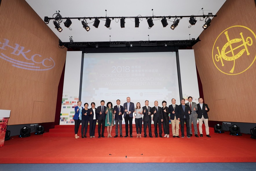 <p>The officiating guests Mr Lau Kong-wah JP, Secretary for Home Affairs (6<sup>th</sup> from right); Miss Donna Tang, Executive Manager, Charities (Grant Making &ndash; Sports and Environment) of The Hong Kong Jockey Club (5<sup>th</sup> from right); and Ms Vivien Lau BBS&nbsp;JP, Chairman of the Hong Kong Coaching Committee (5<sup>th</sup> from left) congratulated the Coach of the Year awardees including Kwok Hart-wing (7<sup>th</sup> from right), Chiu Wing-yin (8<sup>th</sup> from right), Octavian Zidaru (7<sup>th</sup> from left), and Lo Wan-kei (6<sup>th</sup> from left). They took a group photo with other guests on stage.</p>
