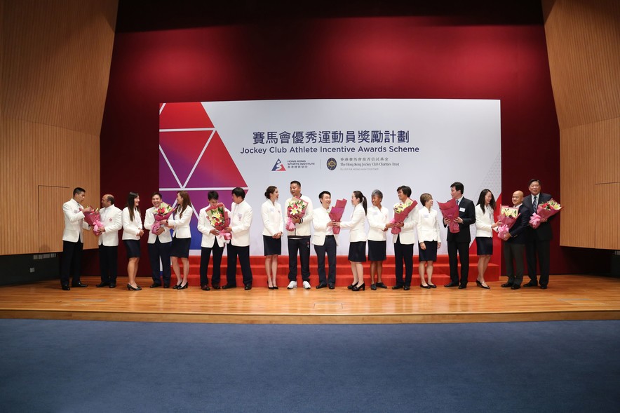 Representatives of the Hong Kong Olympians present flower bouquets to thank the coaching teams for their guidance and support.