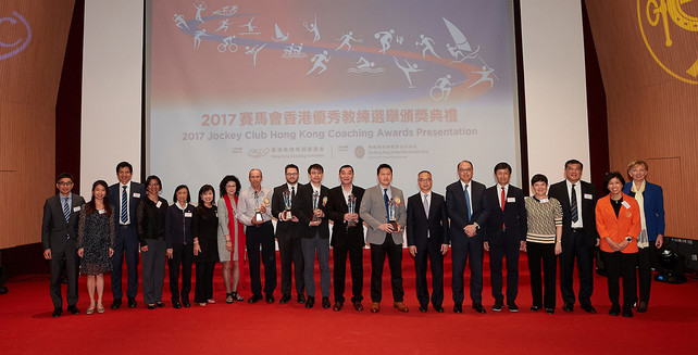 The officiating guests Mr Lau Kong-wah JP, Secretary for Home Affairs (7<sup>th</sup> from the right); Ms Rhoda Chan, Head of Charities Project (Grant Making – Sports, Recreation, Arts and Culture) of The Hong Kong Jockey Club (6<sup>th</sup> from the left); Ms Vivien Lau BBS JP, Chairman of the Hong Kong Coaching Committee (7<sup>th</sup> from the left) and Dr Lam Tai-fai SBS JP, Chairman of the Hong Kong Sports Institute (6<sup>th</sup> from the right) congratulated the Coach of the Year awardees including Lam Chi-pang (Middle), Wang Chang-yong (9<sup>th</sup> from the right), Leung Kan-fai (8<sup>th</sup> from the right). They took a group photo with other guests on stage.