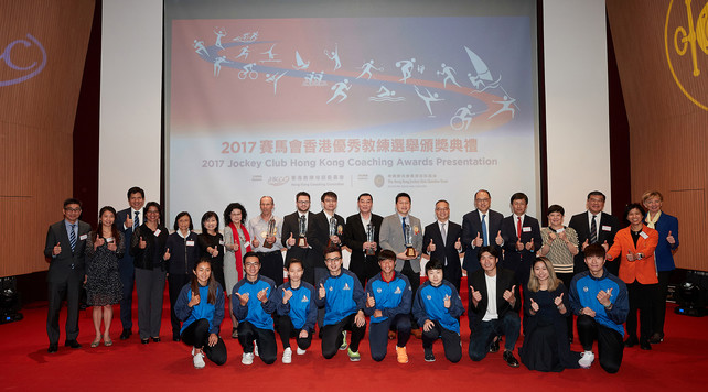 The officiating guests Mr Lau Kong-wah JP, Secretary for Home Affairs (back row, 7<sup>th</sup> from the right); Ms Rhoda Chan, Head of Charities Project (Grant Making – Sports, Recreation, Arts and Culture) of The Hong Kong Jockey Club (back row, 6<sup>th</sup> from the left); Ms Vivien Lau BBS JP, Chairman of the Hong Kong Coaching Committee (back row, 7<sup>th</sup> from the left) and Dr Lam Tai-fai SBS JP, Chairman of the Hong Kong Sports Institute (back row, 6<sup>th</sup> from the right) took a group photo with the Coach of the Year awardees including Lam Chi-pang (back row, middle), Wang Chang-yong (back row, 9<sup>th</sup> from the right), Leung Kan-fai (back row, 8th from the right), together with other guests and athletes on stage.